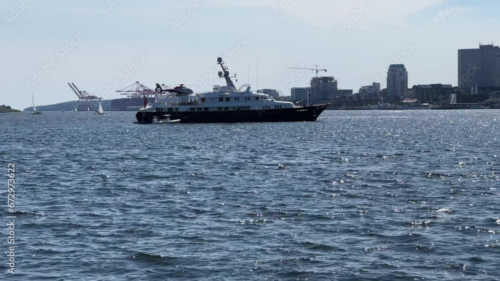 luxury yacht with a helicopter on board is anchored in Halifax Harbor, Canada. luxury yacht with a helicopter on board is anchored in Halifax Harbor, Canada.