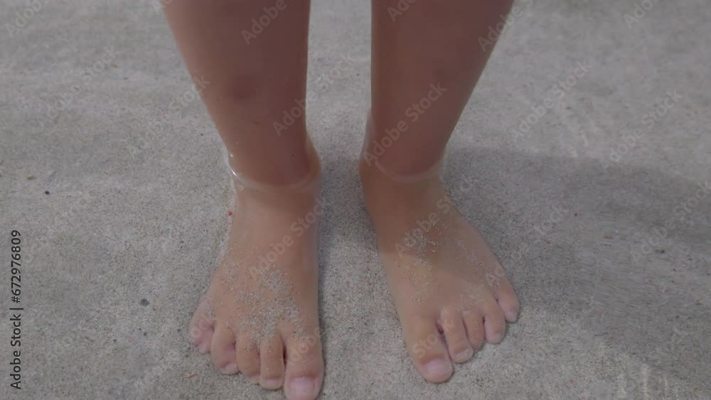 Small girls feet in shallow sea Small girls feet in shallow sea