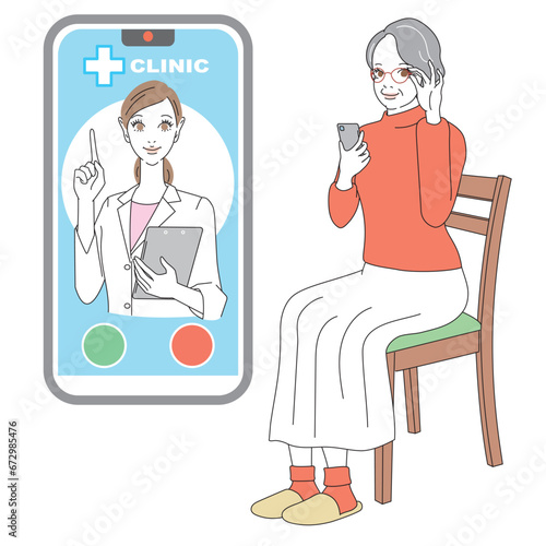 スマートフォンでオンライン診療を受けるシニア女性