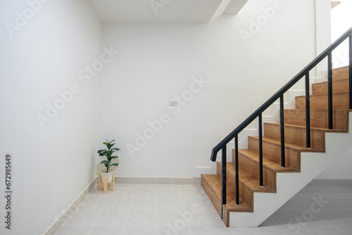 Wood staircase inside contemporary white modern house interior.