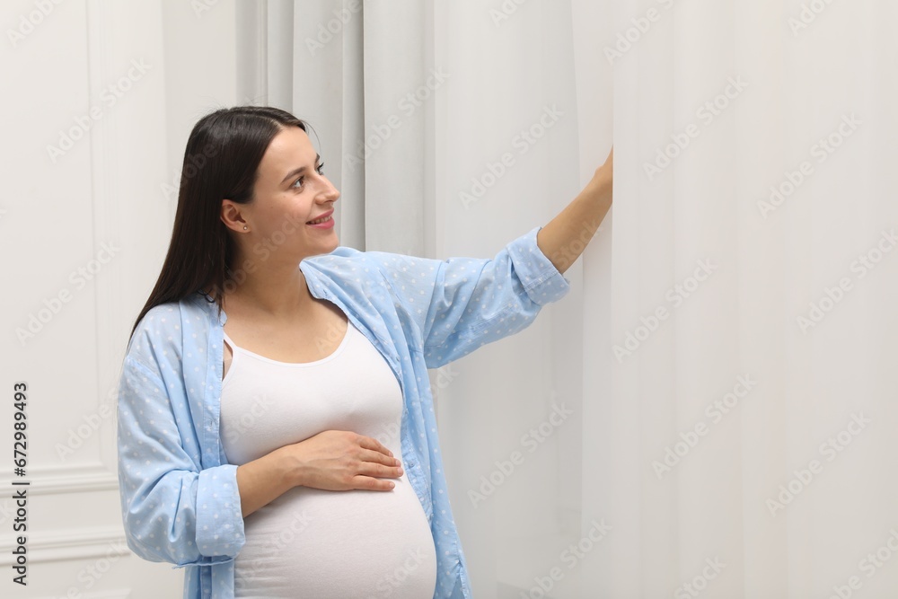 Beautiful pregnant woman in blue shirt indoors Beautiful pregnant woman in blue shirt indoors