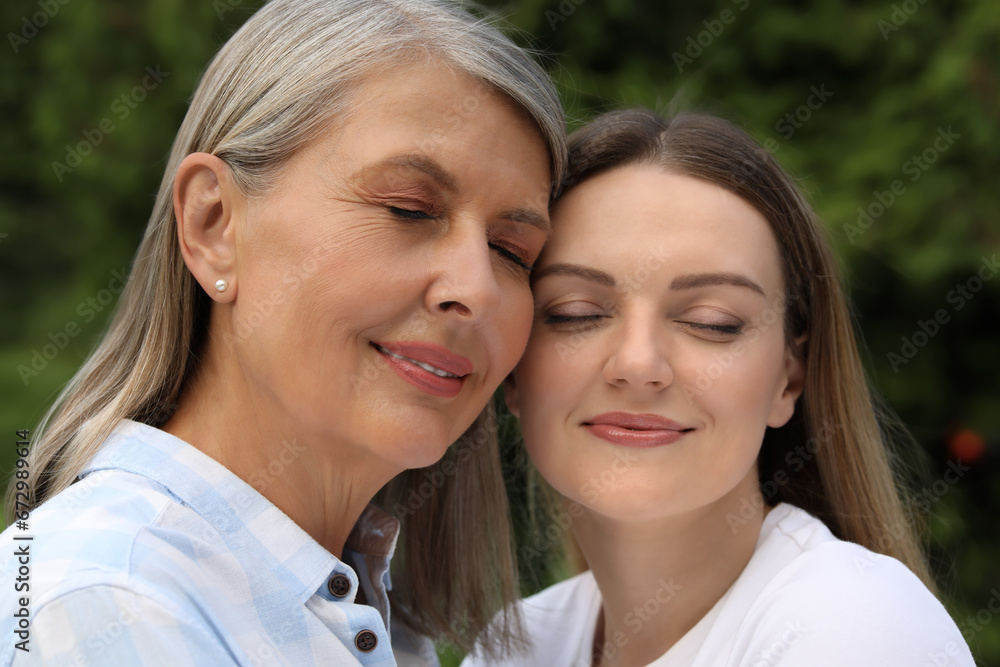 Happy mature mother and her daughter outdoors Happy mature mother and her daughter outdoors