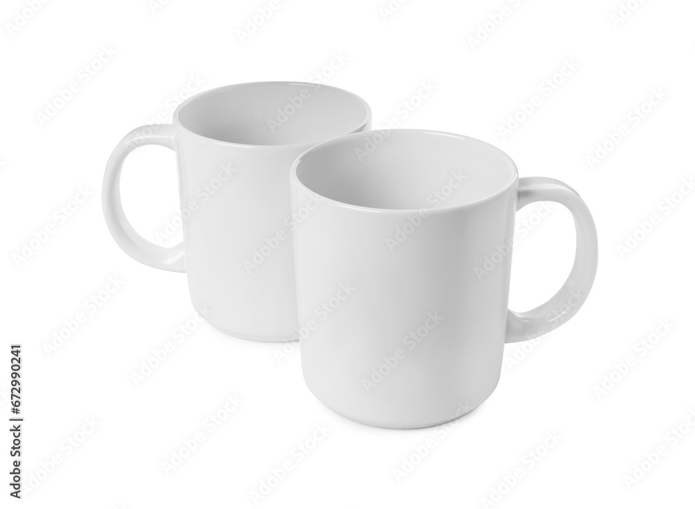 Fototapeta premium Two light ceramic mugs isolated on white