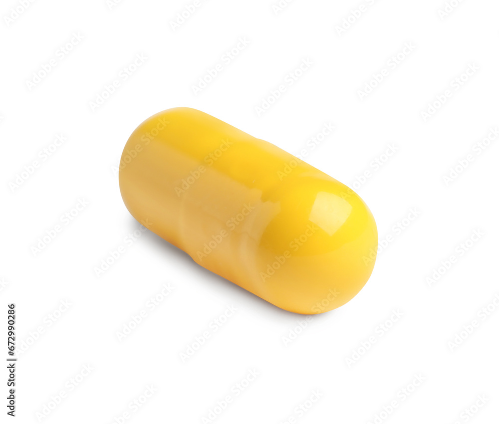 One yellow pill on white background. Medicinal treatment