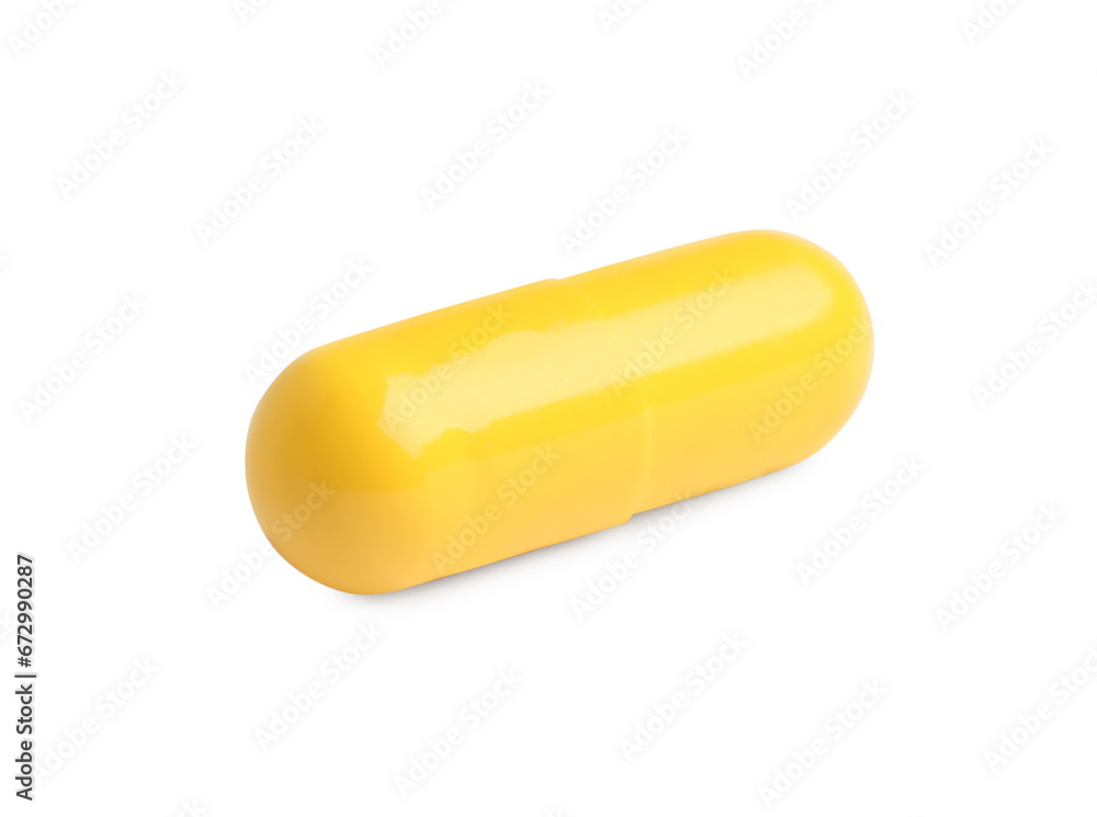 One yellow pill on white background. Medicinal treatment