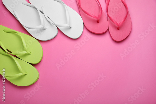 Different stylish flip flops on pink background, flat lay. Space for text