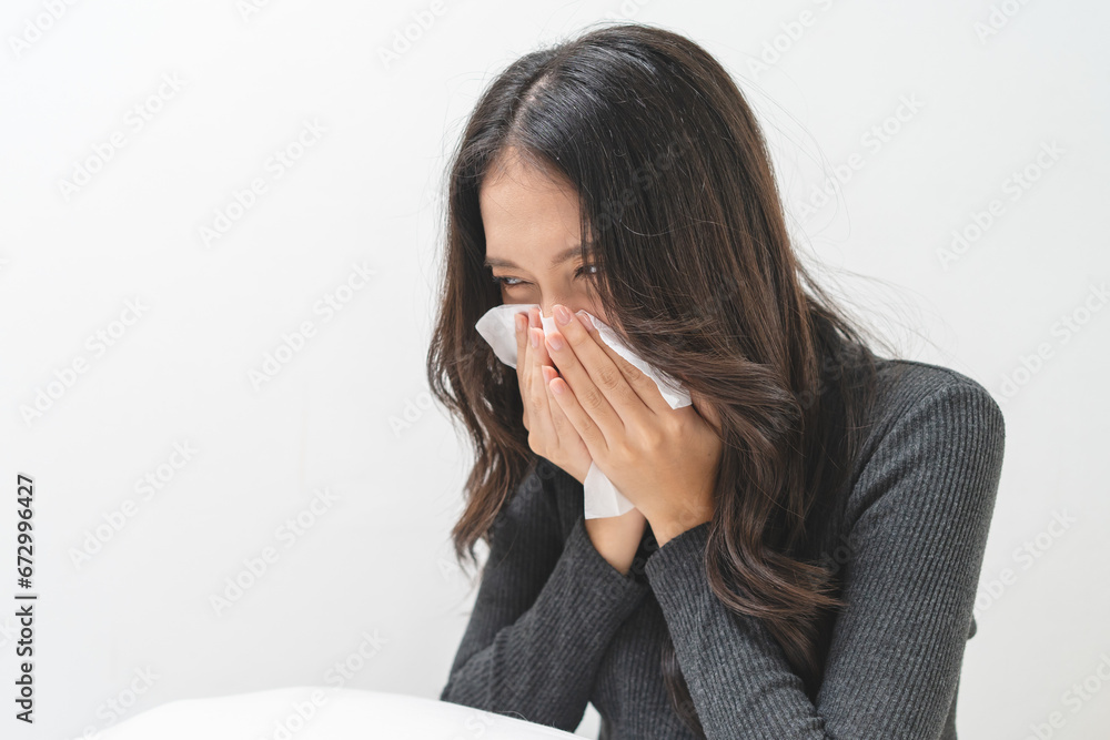 Seasonal sick, woman sneezing and have the flu in the winter season Seasonal sick, woman sneezing and have the flu in the winter season
