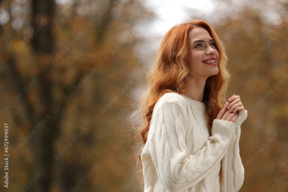 Autumn vibes. Portrait of smiling woman outdoors. Space for text
