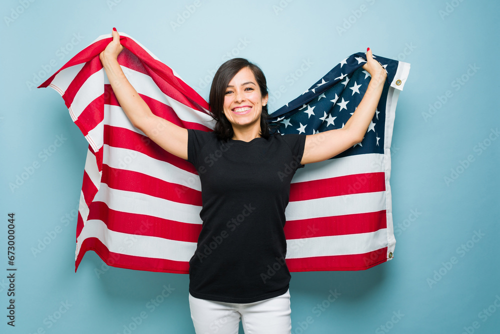 Fototapeta premium Cheerful caucasian woman loving the american dream and US flag