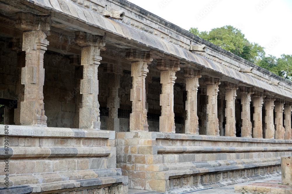 Row of pillars in ancient temple corridor. Stone Columns with Bas-relief carvings at Airavatesvara Temple, Darasuram, Kumbakonam, Tamilnadu.