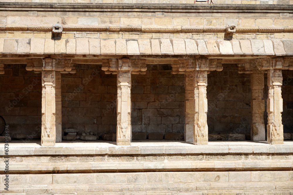 Row of pillars in ancient temple corridor. Stone Columns with Bas-relief carvings at Airavatesvara Temple, Darasuram, Kumbakonam, Tamilnadu.