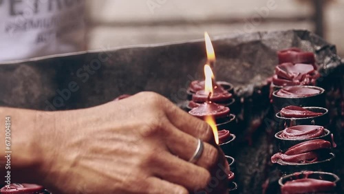 Hand lighting up a candle offering during Undas or Kalag kalag, a Catholic religious tradition in Filipino culture to remember the souls of the dead photo