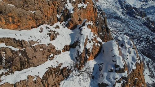 Wallpaper Mural A drone view of a herd of mountain goats running the Steep slope.Wild mountain goats on rugged cliffs on a snowy day.They climb the steep cliff.Mountain goats living in mountainous.Great natural view. Torontodigital.ca