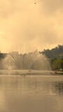 ooty lake with boats and fountain during golden hour at sunrise and sunset.