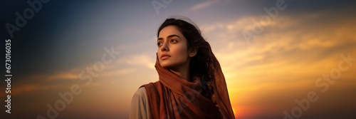 Indian woman looking at sunset sky