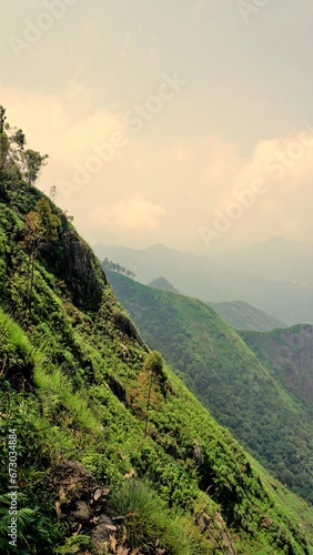 Beautiful dense green lush landscapes of kodaikanal hillstation filled with mist and cloudy sky. photo