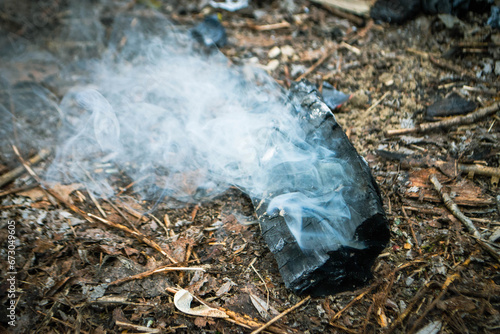 A piece of broken glass with smoke coming out of it.