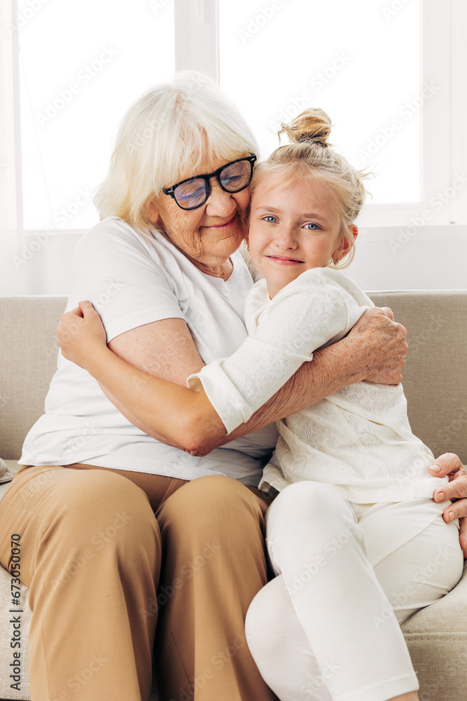 Love family child grandmother hugging happy sofa granddaughter couch home girl
