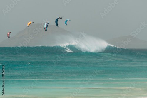 Kite Surfer auf sehr großen Wellen im stürmischen Ocean  photo