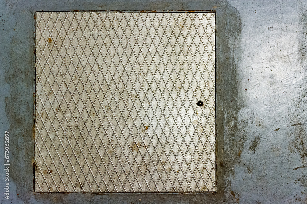 A secret hatch with a metal door built into the concrete floor. Entrance to the tunnel. Entrance to the basement. Cover in case of impact. A secret hatch with a metal door built into the concrete floor. Entrance to the tunnel. Entrance to the basement. Cover in case of impact.