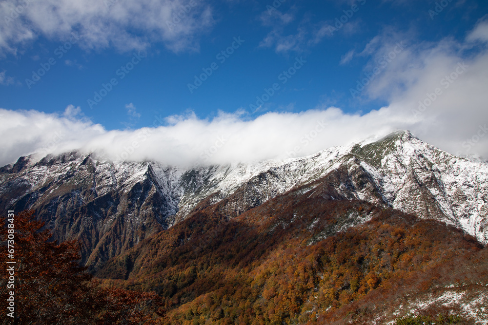 View of Mount Tanigawa with Autumn leaves and snow, Gunma, Japan