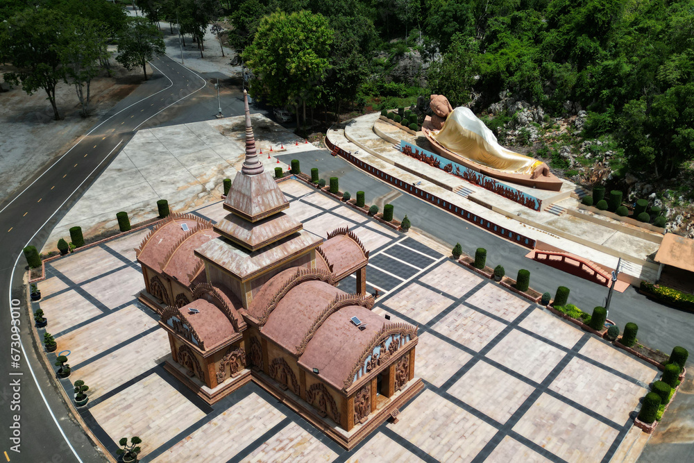 Sandstone castle and large outdoor reclining Buddha at Tham Phu Wa Temple It is a Thai art form. It is reddish brown. It has a beautiful. Located at Kanchanaburi Province in Thailand.
