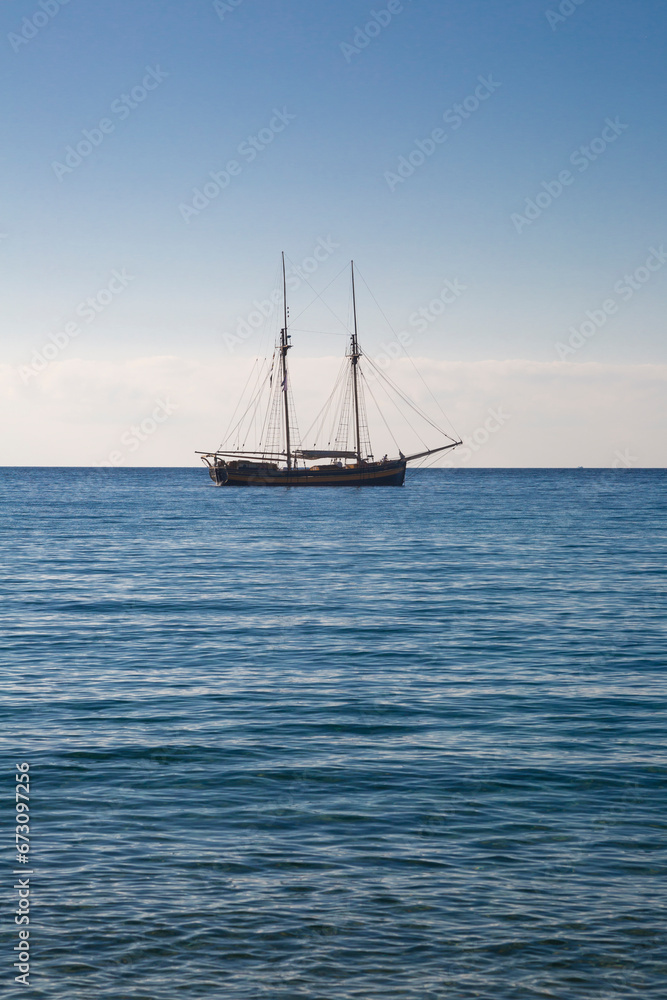Fototapeta premium Wooden boat with two masts at anchor