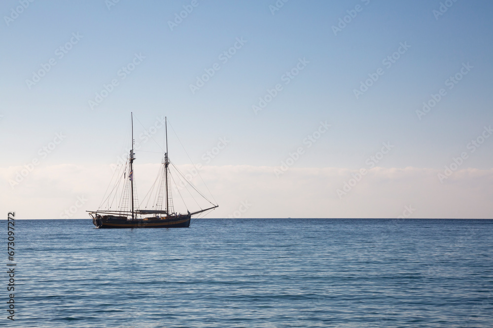 Fototapeta premium Wooden boat with two masts at anchor