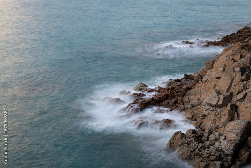 the sea crashing against the rocks