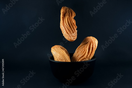 Bengali dessert Goja or Khaza on a bowl. Goja is made of flour and ghee, deep fried and soaked in sugar syrup. It is a popular sweet prepared during festivals like Diwali, Holi, Eid photo