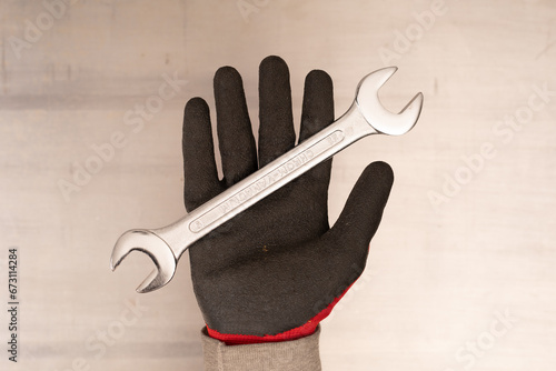 Wrench in hand closeup on w...