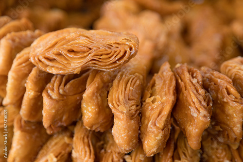 Khaja snacks layered fritters dunked In sugar syrup, for sale in puri odisha india. photo