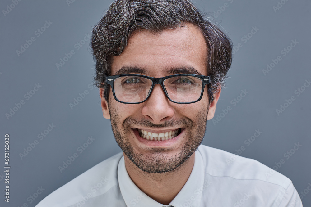 Fototapeta premium portrait of a young man on a gray background in a shirt with glasses smiling