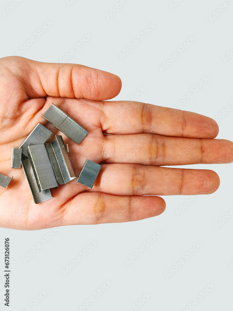 sharp metal staples refill placed in hand, high angle view, isolated with white background sharp metal staples refill placed in hand, high angle view, isolated with white background