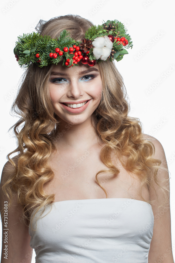 Naklejka premium model woman with long wavy hair, makeup and colorful natural winter decoration on white studio wall background, fashion beauty portrait