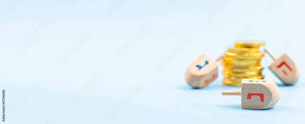 Jewish holiday Hanukkah concept. Traditional wooden dreidel - spinning top and chocolate coins gift. Jewish holiday Hanukkah concept. Traditional wooden dreidel - spinning top and chocolate coins gift.