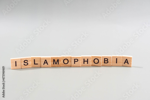 Islamophobia minimalistic concept. Isolated wooden letter blocks with word cloud Islamophobia. 