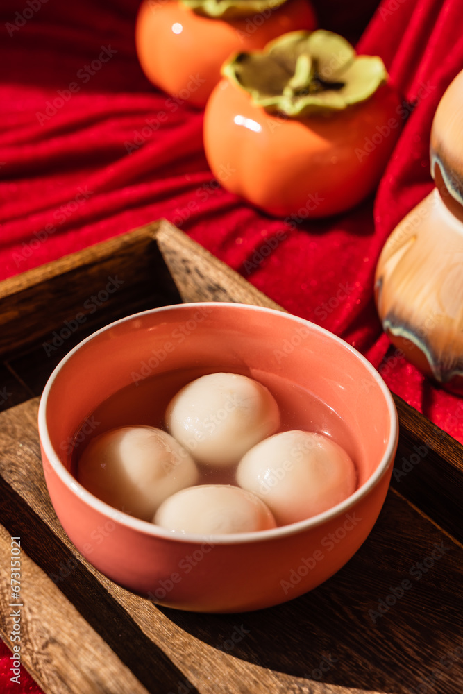 Chinese traditional festival delicacy sweet soup balls on a wooden tray Chinese traditional festival delicacy sweet soup balls on a wooden tray