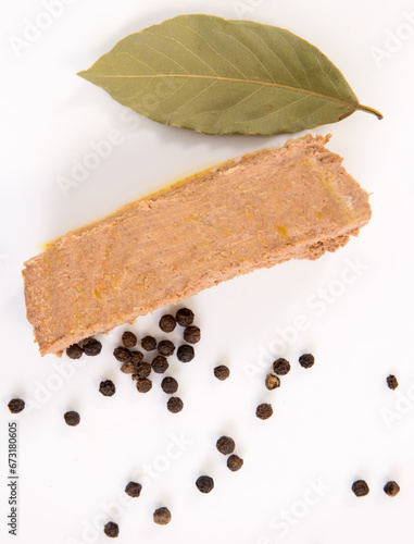 piece of beef pork liver pate on the white background with peppers