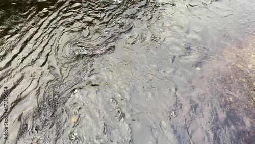 Gentle running river water after an autumn rainfall.