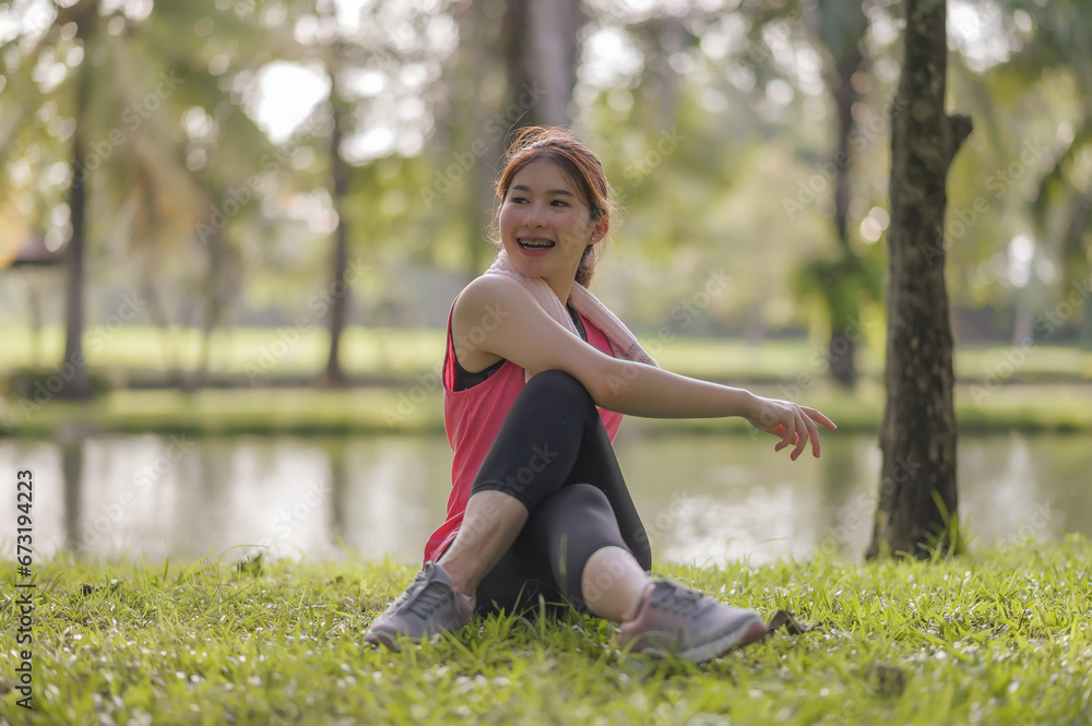 Asian young women enjoy exercising in the public park. Stretching the body and taking a breath of fresh air. The fresh air helps to feel more energized. Asian young women enjoy exercising in the public park. Stretching the body and taking a breath of fresh air. The fresh air helps to feel more energized.