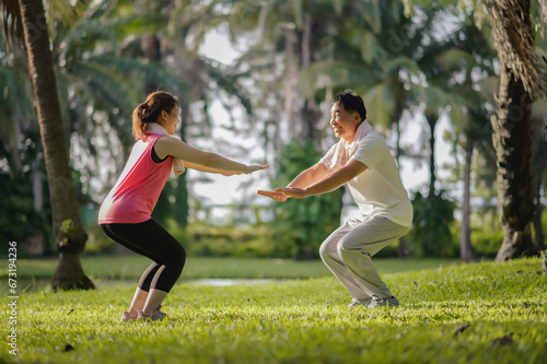 Asian Elderly Father and Daughter Enjoyed Exercising Together in The Natural Green Park. Health care and family bonding.