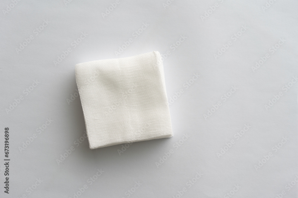 Fototapeta premium Stack of sterile gauze pad on dark background