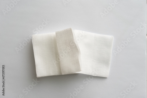 pair of foled gauze pads on white background. photo