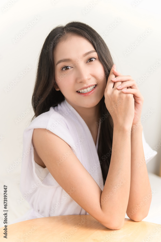 Portrait photo of young beautiful Asian woman taking care of her facial skin after apply face skin care cosmetic lotion moisturizer product and checking in mirror at home. Beauty care concept Portrait photo of young beautiful Asian woman taking care of her facial skin after apply face skin care cosmetic lotion moisturizer product and checking in mirror at home. Beauty care concept