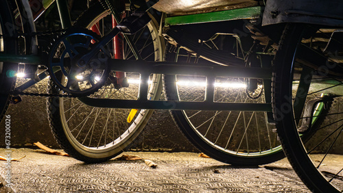 backlight photo art of the bottom of a parked pedicab with artistic lighting photo