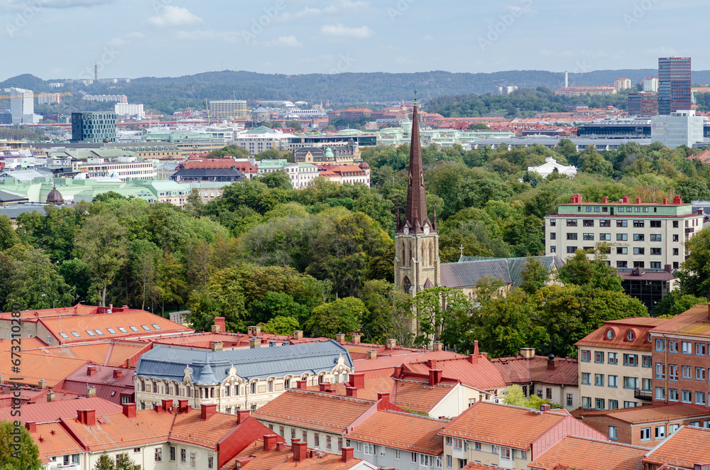 Aerial view of the Haga church (Hagakyrkan) in Gothenburg, Sweden surrounded by red rooftops and green trees