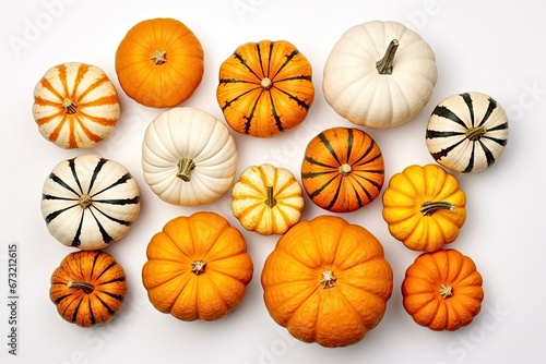 Assortment of autumn pumpkins isolated on a white background. Top view. Striped, orange and white