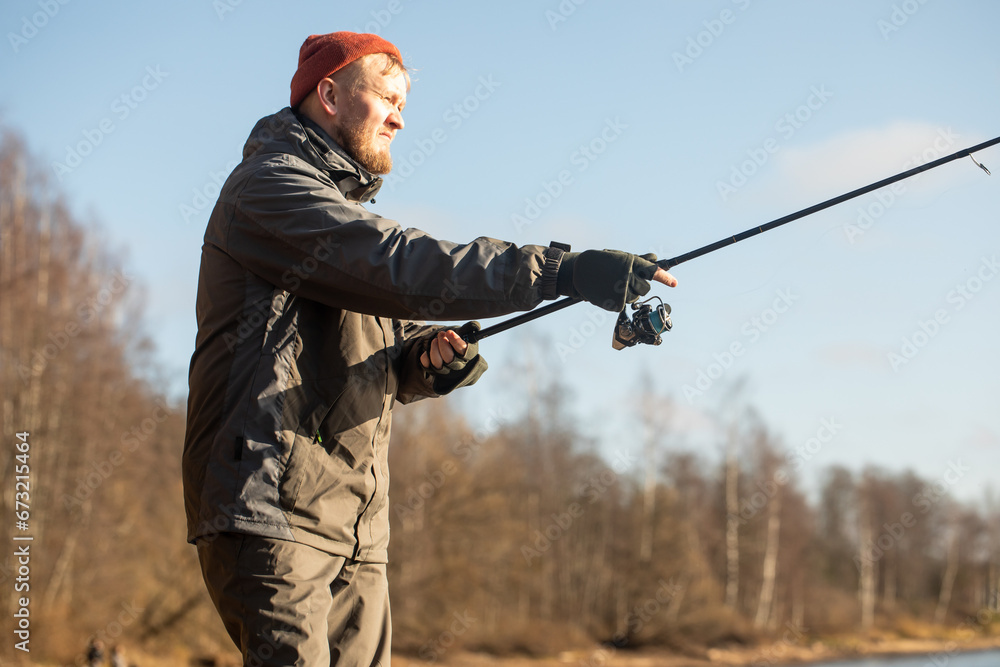 Fototapeta premium fisherman fishing on the river bank, Fishing rod, spinning