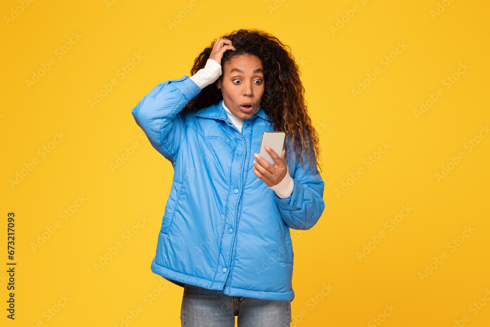 Shocked lady reads bad message on phone, touches head Shocked lady reads bad message on phone, touches head